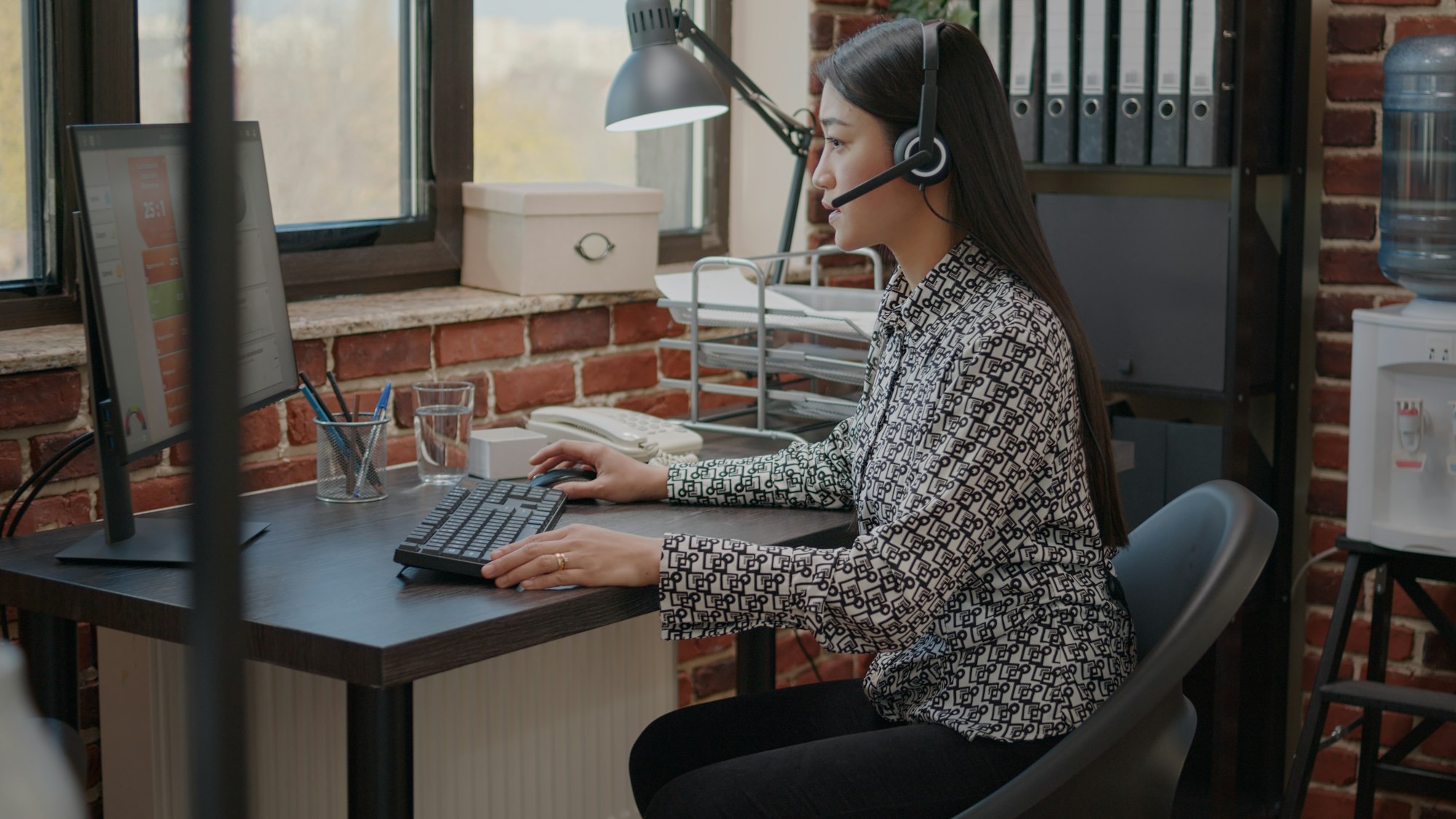 Call center operator talking to clients on phone call with microphone