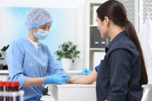 Nurse drawing blood from patient in medical office