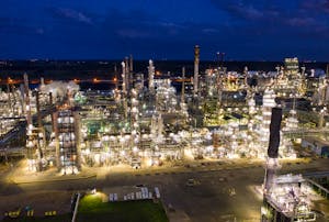 Aerial view of a brightly lit industrial refinery at night in Rosemount, MN.